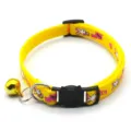 Close-up of yellow pet collar detail featuring cute cat buckle, metal bell, and printed pattern. - Yellow