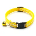 Detailed view of bright yellow pet cat collar with white pattern and cute golden bell. - Yellow
