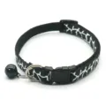 Close-up of black and white patterned cat collar detail, with bell and safety buckle. - Black