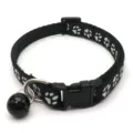 Detailed view of the 1.0cm black pet collar with white paw prints, bell, and secure buckle. - Black
