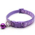 Purple pet collar detail, nylon strap with paw prints, safety buckle, and a cute metal bell. - Light Purple