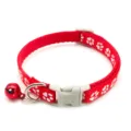 Red nylon pet collar detail close-up, featuring cute white paw prints and a red bell. - Red