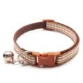 Brown and white checkered pet collar detail showing durable fabric strap and metal bell. - Coffee