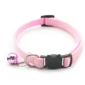 Close-up of pink cat collar with cute cat face buckle, metal D-ring and shiny bell detail. - Pink