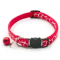 Detailed view of red print cat collar featuring cute black cat buckle and metal bell accessory. - Red