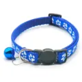 Blue pet collar detail featuring white paw print pattern, black buckle and blue bell. - Blue