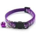 Purple pet collar with cute white paw print pattern, adjustable design and hanging bell. - Purple