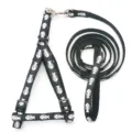 Black pet harness and leash set with white fish bone print for dogs and cats walking supplies. - Black
