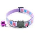 Purple cat collar detail showing cute heart print pattern, safety buckle and metal bell. - Lavender