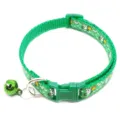 Green pet collar detail showing the buckle and bell with cartoon print pattern. - Green