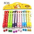 Colorful printed pet collars with bells, cat and dog fabric necklaces on card display. - FC35