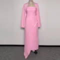 Detail view of the pink two-piece dress featuring a long-sleeve shrug and strapless slit long gown. - S / Pink