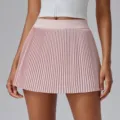 Detailed view of the pink pleated tennis skort, showing fine pleats and high waist design. - Hibiscus Pink