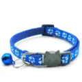 Blue pet collar detail, featuring cute white paw prints, cat shaped buckle and a shiny bell. - Blue