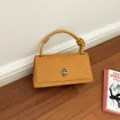 Retro woven baguette handbag with stylish knot handle, elegant shoulder purse for daily commute. - Yellow