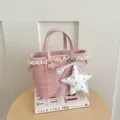Pink tweed bucket bag detail showcasing delicate lace trim and cute star pendant charm. - With Pendant / Pink