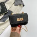 Mini black tweed crossbody bag with gold chain strap and elegant turn-lock closure for women. - Black
