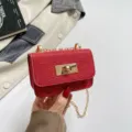 Red sequin mini crossbody bag detail, featuring gold-tone hardware and chic turn-lock closure. - Red