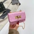 Pink patent leather polka dot mini shoulder bag detail showing gold chain and chic turn-lock closure. - Pink Polka Dot