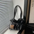 Black pleated shoulder bag for women, trendy tote purse with cute bear charm and slouchy design. - Black