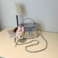 Silver quilted vanity shoulder bag with cute plush puppy pendant and chain strap variant. - Silver