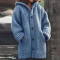 Blue hooded knit cardigan sweater detail showing soft texture, long sleeves and button closure. - Blue