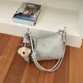 Silver woven shoulder bag with stylish knotted straps and cute puppy keychain accessory. - Silver (With Pendant)