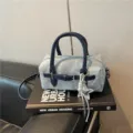 Detail view of denim Boston handbag, stylish fabric with dark blue handles and cute star charm. - With Pendant / Blue