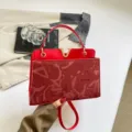 Chic red shoulder handbag for women, top handle bag with metal V clasp and debossed pattern. - Red