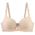 Detail shot of seamless padded bra cup texture, smooth solid color surface and adjustable strap. - 75B / Nude