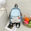Casual light blue backpack with orange bungee cord, stylish travel bookbag for daily school use. - Blue