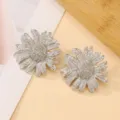 Silver sunflower floral earrings detailed shot, textured metallic petals and sparkling center design. - Sunflower Silver Earrings