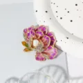 Detailed shot of a purple enamel peony brooch with central pearl and sparkling rhinestones. - Purple