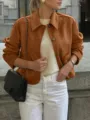 Detail view of the retro brown suede jacket with lapel and buttons in urban street scene. - S / Coffee