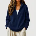 Close-up detail of the deep V-neck waffle knit sweater texture and sleeve cuff finish. - Navy Blue