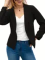 Detail view of a stylish black open-front blazer jacket paired with a white top and jeans. - S / Tops / Black