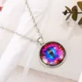 Close-up detail shot of the colorful glass eye pendant necklace with silver chain and gemstone. - Antique Silver & Red
