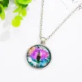 Close-up detail of the colorful cat eye glass cabochon pendant necklace with silver chain. - Antique Silver + Purple