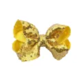 Detailopname van gouden pailletten haarstrik, sprankelende haarspeld voor kinderen en dames. - Geel