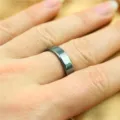 Magnetic hematite ring closeup detail showing multi-faceted cut and dark polished surface. - Size 17 / Square Edge