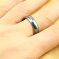 Close-up detail shot of smooth magnetic ring worn on finger, minimalist style daily jewelry. - Size 17 / Round Edge