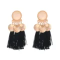 Close-up detail of bohemian alloy metal frosted disc black tassel earrings, stylish design. - Black