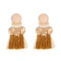 Detail view of the alloy matte round disc and tassel earrings, bohemian style chic. - Turmeric