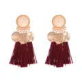 Close-up detail of bohemian burgundy tassel earrings with gold alloy frosted round discs. - Burgundy