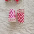 Close-up detail of pink and white chevron paper cups on furry background, party tableware decor. - 12 Rippled Paper Cups 270ml / Rose Red
