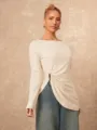 Close-up detail of the irregular metal buckle and side split on the elegant long-sleeve top. - S / Tops / Apricot