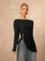 Detailed view of the stylish women's long sleeve black top featuring an irregular metal buckle. - S / Tops / Black