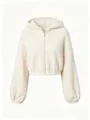 Detail view of a cozy beige sherpa zip-up hoodie featuring soft fleece texture and metal zipper. - S / Tops / Apricot