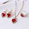 Close-up detail view of the red heart crystal pendant necklace earrings and ring set. - Heart / Red