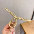 Gold metal hair claw clip with unique twisted design for elegant hairstyles and daily wear. - Threaded Design / Gold